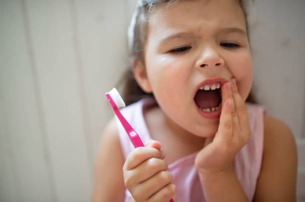 worried small girl with toothbrush